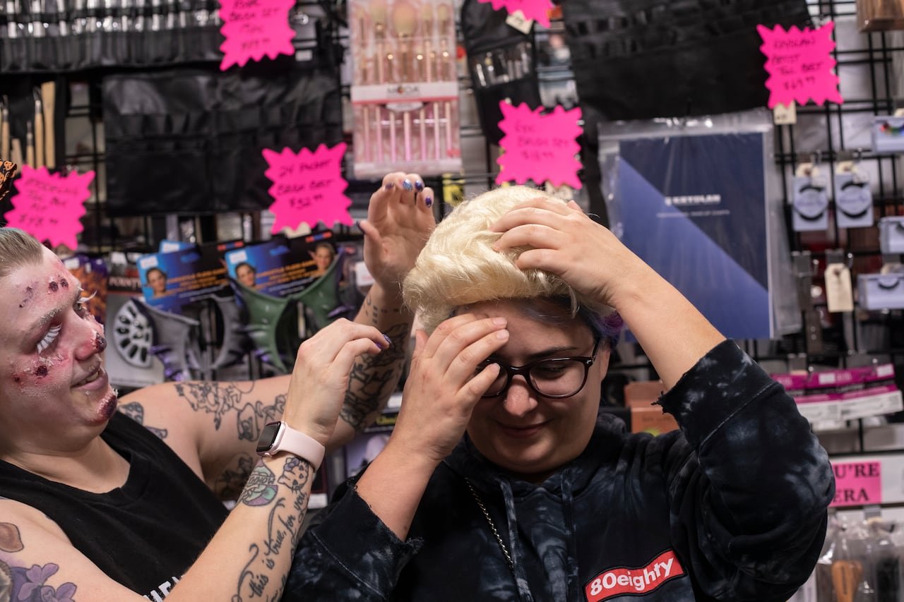 A person tries on a wig.